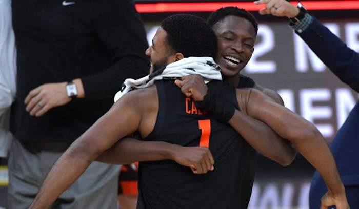 Warith Alatishe hugs Maruice Calloo. Photo by Stephen R. Sylvanie, USA TODAY Sports